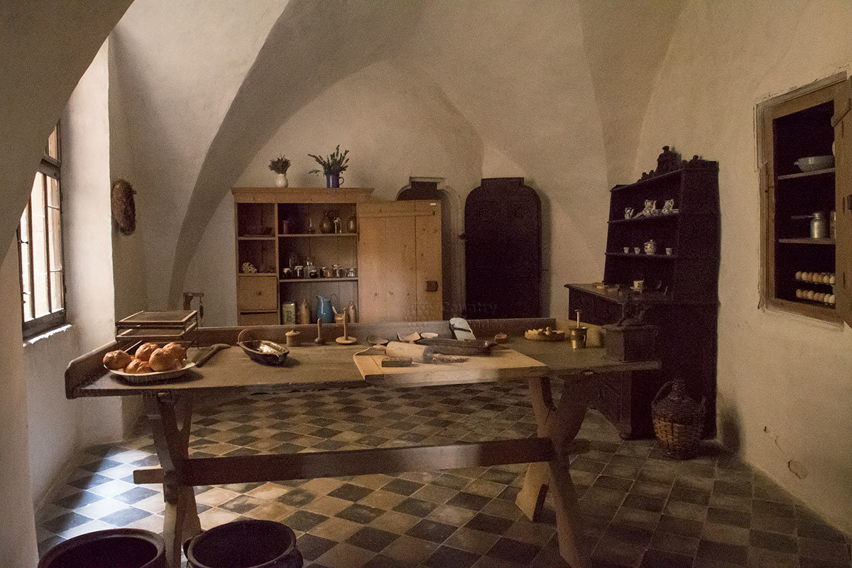 Кулинарное помещение замка Пернштейн демонстрирует стол древнего пекаря с приспособлениями для работы с тестом.